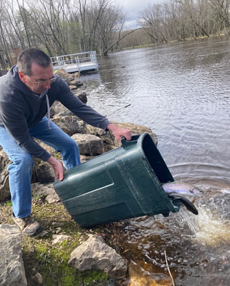 Gary Lemmen & Bill Gerndt placing Trout in Oconto River at Suring
